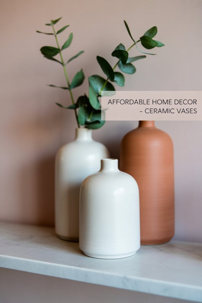 Simple ceramic vases in matte white or earthy tones add sculptural interest. 