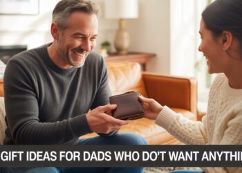 Father in a cozy living room joyfully opening a leather wallet gift from his child, with overlay text reading ‘15 Gift Ideas for Dads Who Don’t Want Anything.’