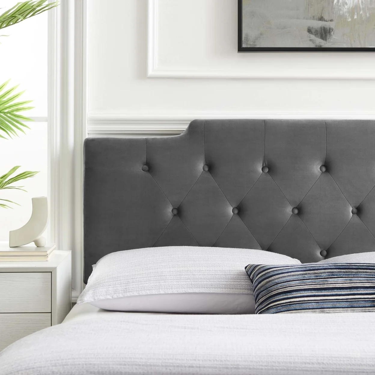 If you want to ground a bright room, go with a dark, moody headboard. 